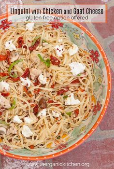 linguini with chicken and goat cheese in an orange bowl on a mosaic tile floor