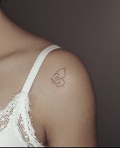 a woman with a small tattoo on her shoulder