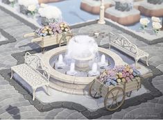 an artistic rendering of a fountain with benches and flowers in the center, surrounded by stone pavers