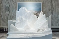 a sculpture made out of white paper in a room