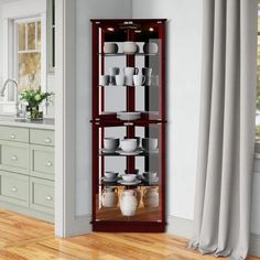 a tall wooden shelf filled with plates and bowls on top of a hard wood floor