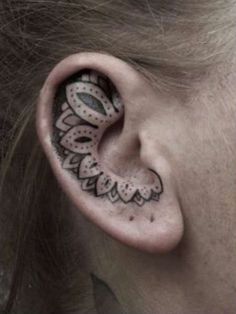 a woman's ear with an intricate design on it