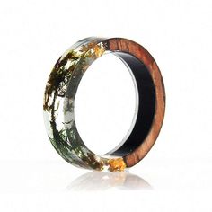 a wooden ring with moss growing on the inside and in between it's sides