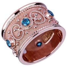 S.Georgios Special Edition Hand Made 18 Karat Rose Gold Eternity Band Ring with 0.68 Carat total weight of Blue Diamonds. This gorgeous ring is microscopically decorated all the way around with gold beads and wires - granulation - shaped like the last letter of the Greek Alphabet - Omega, which symbolizes eternal life, and the ring is finished with a unique velvet look on the background. It can also be ordered in Yellow or White Gold and is all custom made in our workshop in Athens Greece and is Vintage Eternity Band, Rose Gold Eternity Band, Rose Gold Diamond Band, Contemporary Wedding Rings, Byzantine Rings, Eternity Ring Gold, Blue Diamonds, Gold Diamond Band, Rose Gold Diamond Ring