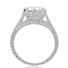 a white gold engagement ring with an oval cut diamond in the center and side stones