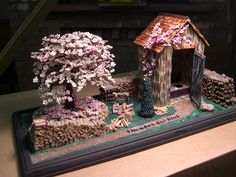 a miniature model of a small house and tree