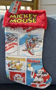 a mickey mouse christmas stocking hanging on a couch