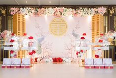 an elaborately decorated stage set up with flowers and gifts for the guests to take home