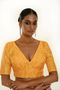 Introducing the Yellow Brocade Blouse with Deep V Neckline and Elbow Length Sleeves—a stunning piece that embodies grace and sophistication. Crafted from rich brocade fabric, this blouse features a striking deep V neckline that enhances your silhouette while the elbow-length sleeves offer a touch of refined elegance. The vibrant yellow color, beautifully complemented by subtle gold accents, makes it a versatile choice for any occasion. Pair it with a saree or lehenga for a polished look that rad Cheap Yellow Festive Blouse, Cheap Yellow Semi-stitched Blouse Piece, Yellow Brocade Blouse, Elbow Sleeve Blouse, Brocade Blouse, Cotton Gowns, Ruffle Saree, Indo Western Dress, Brocade Blouses