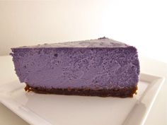 a piece of purple cheesecake on a white plate