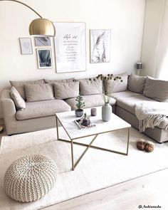 a living room filled with lots of furniture and pictures on the wall above it's coffee table