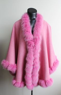 DESCRIPTION: BEAUTIFUL & VERY STYLISH PINK WOOL/ALPACA CAPE WITH FOX FUR TRIMMING FOR WOMEN!  IT HAS SNAP BUTTON CLOSURE. THIS ITEM IS BRAND NEW! MEASUREMENTS:   SIZE: ONE SIZE FITS ALL LENGTH: 27" WHY YOU SHOULD BUY YOUR PRE-OWNED FURS ONLY FROM OUR COMPANY? BECAUSE WE SIZE AND REPAIR OUR COATS BEFORE SHIPPING AND WE OFFER A RETURN POLICY...NO RISK 100% SATISFACTION. BRAND NEW COATS: ONCE MEASUREMENTS ARE RECEIVED (HEIGHT,WEIGHT, CHEST/BUST, SLEEVE LENGTH AND LENGTH OF THE COAT WANTED), YOUR BRAND NEW FUR WILL BE MADE TO MEASUREMENT AND WE CAN GUARANTEE PERFECT FIT, AS A PATTERN WILL BE MADE TO THE SIZE NEEDED AND IF NECESSARY WE CAN CREATE A CLOTH CANVAS, 0% RETURN! LN475 #120-L Oliverfurs 9250 Parc Ave. #204, Montreal, Quebec, H2N 1Z2, Canada www.oliverfurswholesale.com oliver@oliverfur Luxury Pink Wool Outerwear, Cape Shawl, Fur Cape, Pink Fox, Wool Cape, Shawl Wrap, Fox Fur, Fur Trim, Snap Button