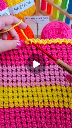 the crochet is being worked on by someone using yarn and scissors to make it