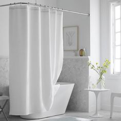 a white bath tub sitting next to a window