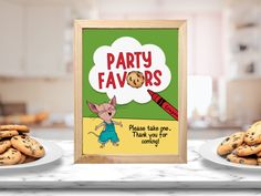 a party favors sign next to cookies on a table with an image of a mouse holding a crayon