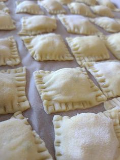 homemade pastries are lined up on a baking sheet