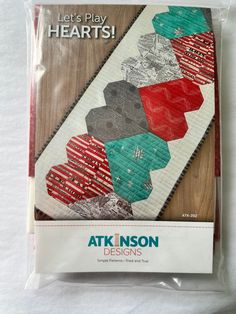 the back side of a quilt kit with red, green and blue designs on it