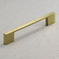 a brass handle on a white counter top