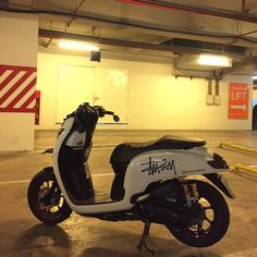 a scooter is parked in an empty parking garage with no one on it