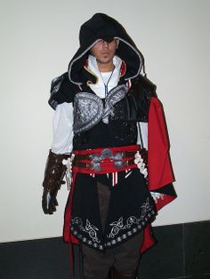 a man dressed in costume standing next to a wall