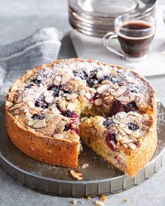 a blueberry coffee cake with one slice cut out