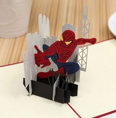 a spiderman pop up card on top of a table