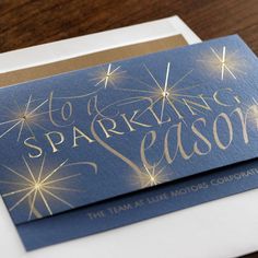 a blue and gold greeting card that says sparkling season