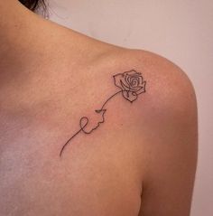 a woman's shoulder with a rose tattoo on the left side of her arm