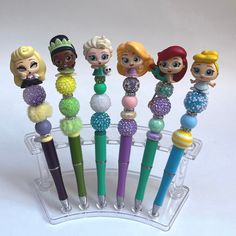 the littlest princesses are lined up in a holder with their pen tops down