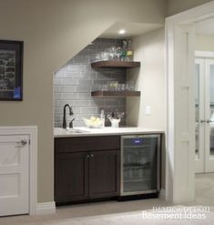 the kitchen is clean and ready to be used as a home bar or wine cellar