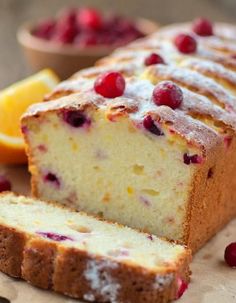 a loaf of lemon cranberry bread with fresh cranberries on the side