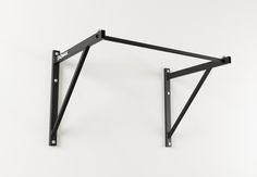 a black metal shelf bracket on a white wall