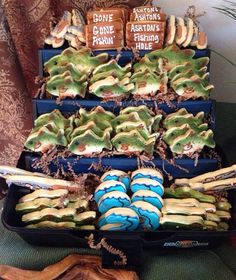 there are many different types of food in the trays on this table, including cookies and marshmallows