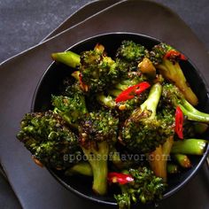 a bowl filled with broccoli and red peppers