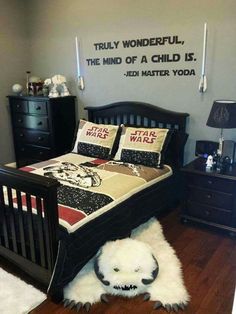 a star wars themed bedroom with a bed, dressers and chest of drawers in the corner