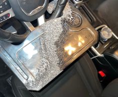 the interior of a car with silver glitter on it