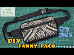 a black and white fanny bag sitting on top of a green cutting board with the words diy fanny pack