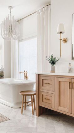 a bathroom with a tub, sink and mirror in it's centerpieces