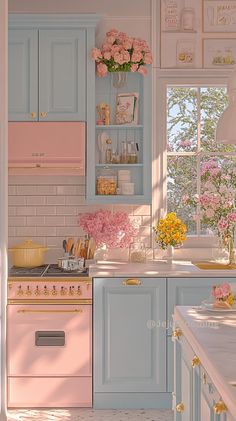 a pink and blue kitchen with flowers in the window