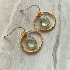 ▫️Green Amethyst crystal dangle earrings on 14 Karat Gold Filled French Hooks ▫️These teardrop earrings have a 14K Gold Filled hammered hoop around them that are suspended from 14K Karat Gold Filled French hooks which make them not only versatile but also ideal for those with sensitive ears as these hooks won't tarnish or irritate those with ear allergies Dainty Gold Amethyst Earrings, Elegant Gold Earrings With Green Amethyst, Gold Amethyst Dainty Earrings, Elegant Gold Amethyst Hoop Earrings, Gold Dangle Earrings With Birthstone, Gold Drop Earrings With Birthstone, Gold Amethyst Earrings Fine Jewelry, Gold Amethyst Earrings With Ear Wire, Gold Amethyst Round Earrings