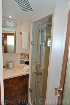 a bathroom with a walk in shower next to a sink