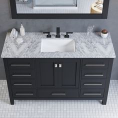 a bathroom sink sitting under a mirror next to a counter top with two sinks on it