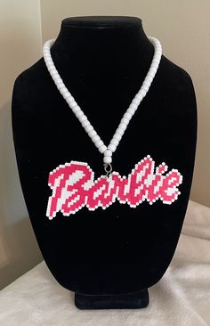 a beaded necklace with the word barbie on it