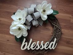 a wreath with flowers and the word blessed on it