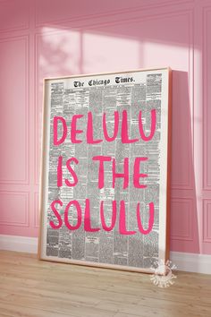 a poster with the words delu is the soul on it in front of a pink wall