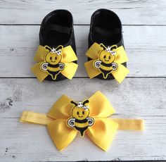 two pairs of black and yellow shoes with a bee on the front, one wearing a headband