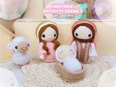 three crocheted nativity scene figurines sitting on a doily