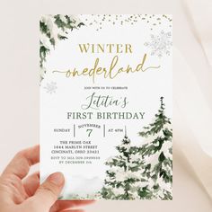 a person holding up a card that says winter onederland with evergreens and snowflakes on it