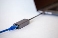 a blue cable connected to a laptop computer