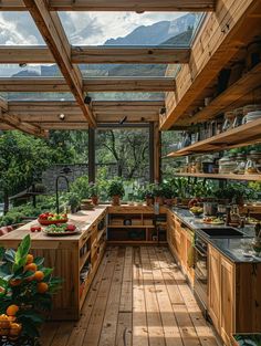 an outdoor kitchen with wooden floors and skylights over the counter top, surrounded by greenery